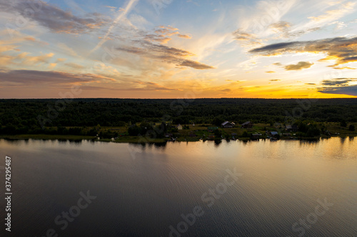 panoramic view of the lake with many islands on one of them there is an ancient temple made of wood at sunset filmed from a drone