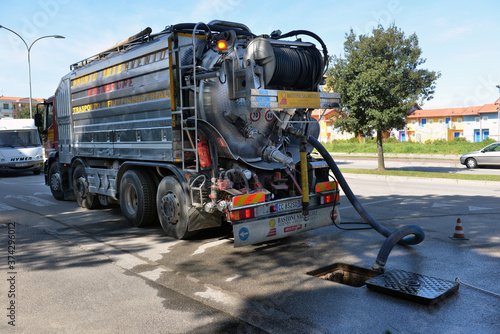 ITALY, CAORLE,15, APRIL, 2016, cleaning truck pumps out the water drain, ITALY, CAORLE,15, APRIL, 2016