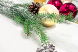 pine cones and branches and Christmas balls on a light wooden background. christmas background