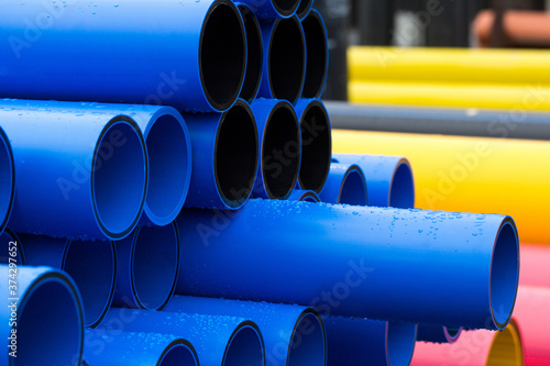 Plastic pipe is stockpiled for storage in the open air © Alexey