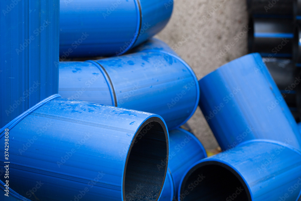 Plastic pipe is stockpiled for storage in the open air Plastic pipe is stockpiled for storage in the open air
