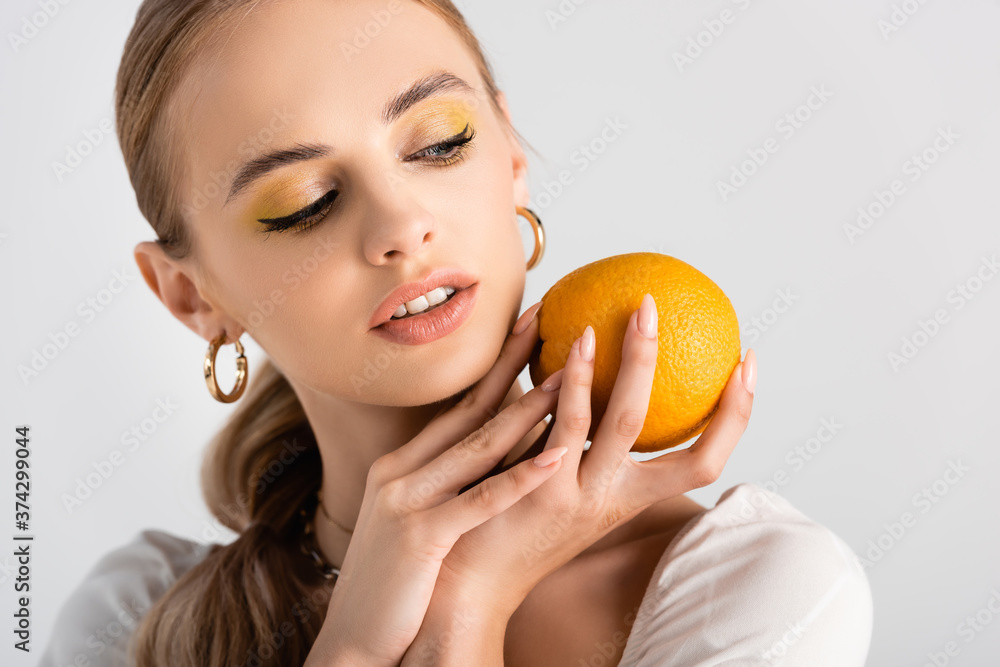 elegant blonde woman posing with orange isolated on white elegant blonde woman posing with orange isolated on white