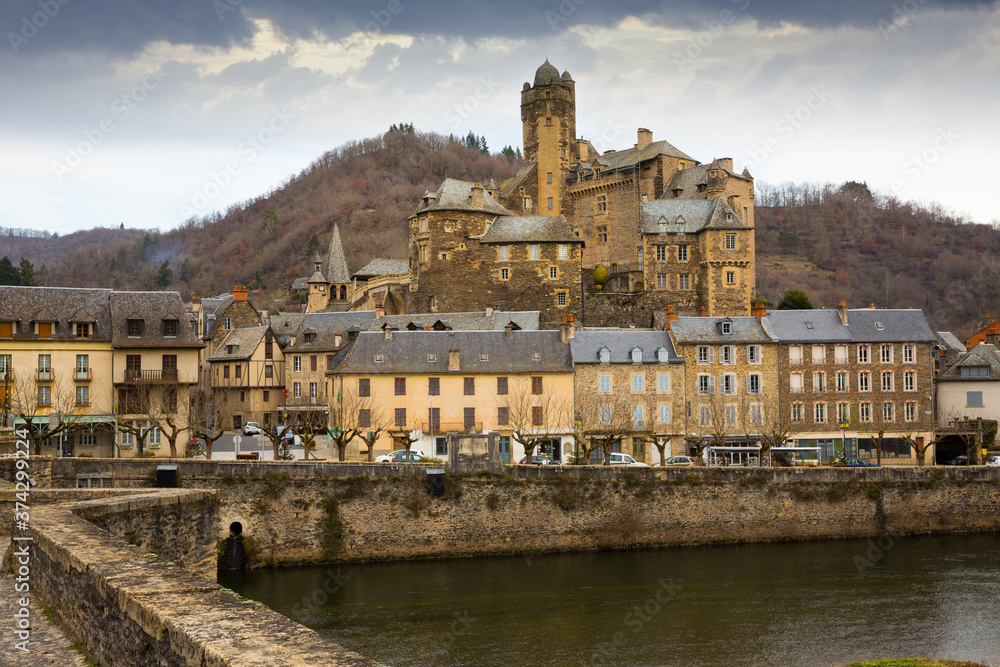 View of medieval castle in picturesque village of Estaing on bank of Lot river, Aveyron, France