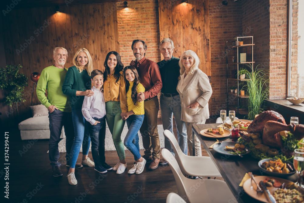 Fototapeta premium Portrait of nice attractive affectionate cheerful family gathering spending vacation festal weekend celebratory occasion November at modern loft industrial brick interior house