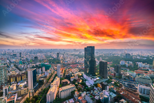  High view Saigon skyline when the sun shines down urban areas with tall buildings along the road show development country in Ho Chi Minh, Vietnam