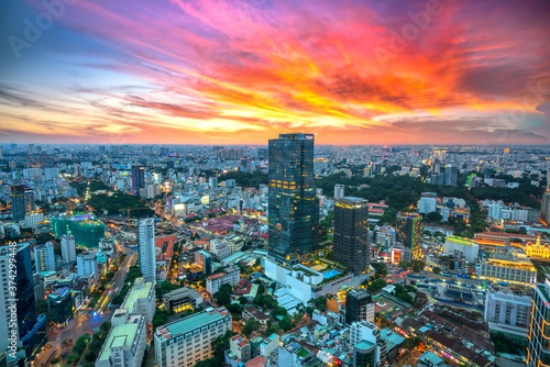  High view Saigon skyline when the sun shines down urban areas with tall buildings along the road show development country in Ho Chi Minh, Vietnam © huythoai