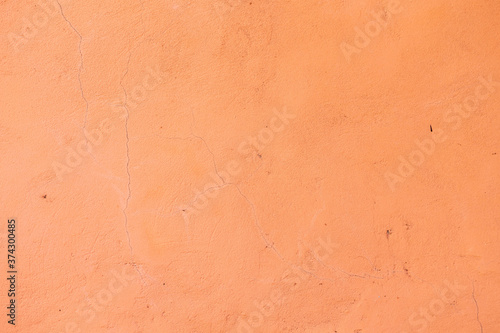 Background and texture of a concrete wall painted with salmon paint