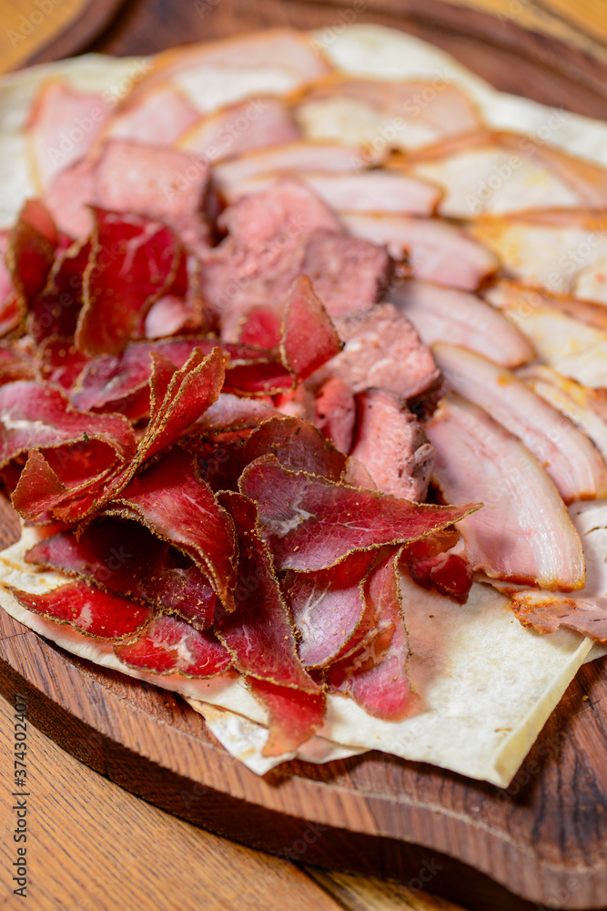 Obraz premium Georgian meat with garlic. Georgian food, Georgian dishes. Traditional cuisine concept. Different kinds of meat.