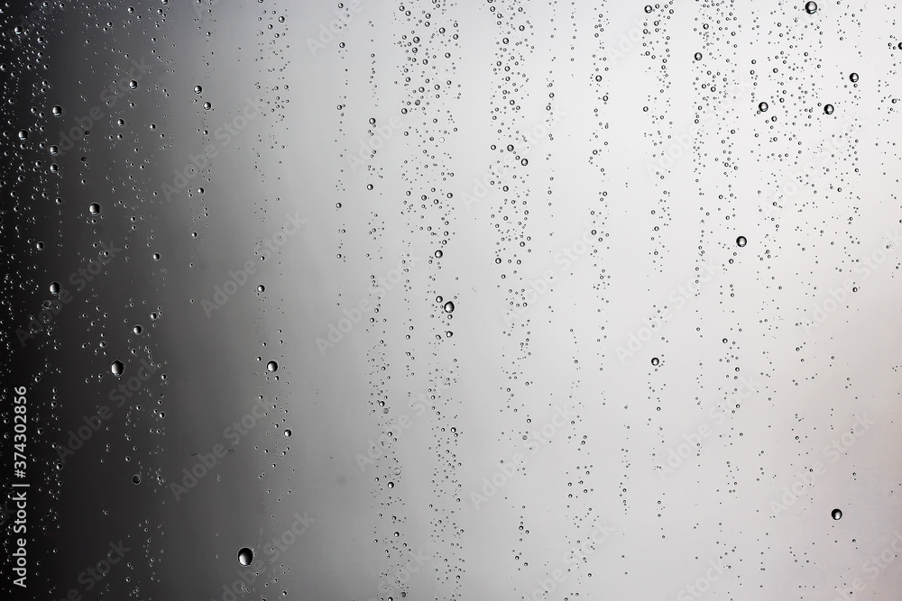 black wet background / raindrops for overlaying on window, concept of autumn weather, background of drops of water rain on glass transparent