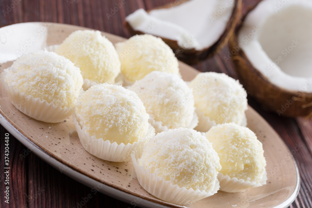 White chocolate candies with coconut topping close up White chocolate candies with coconut topping close up