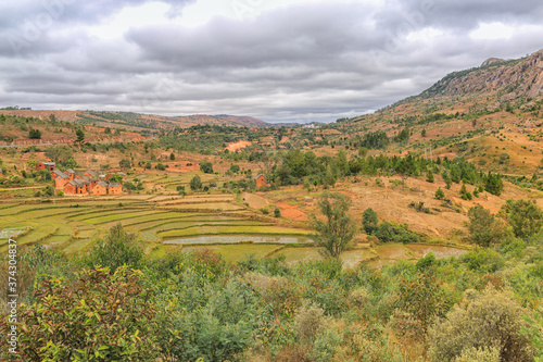 Rice terraces against the background of mountains and cloudy sky in Madagascar