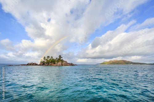 St. Peter's Island in the Seychelles with a rainbow above it.