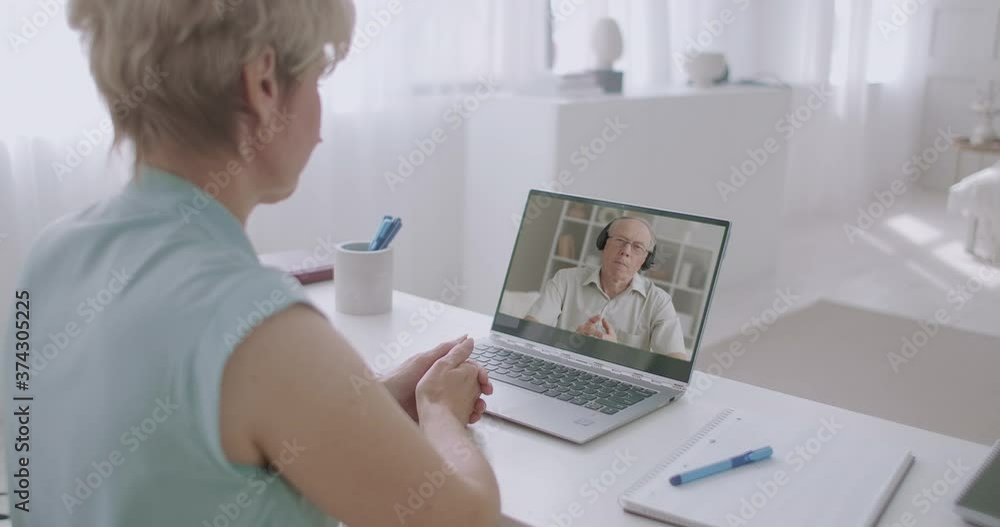 man and woman are communicating online by video chat at laptop, spouses from different cities are chatting by internet man and woman are communicating online by video chat at laptop, spouses from different cities are chatting by internet