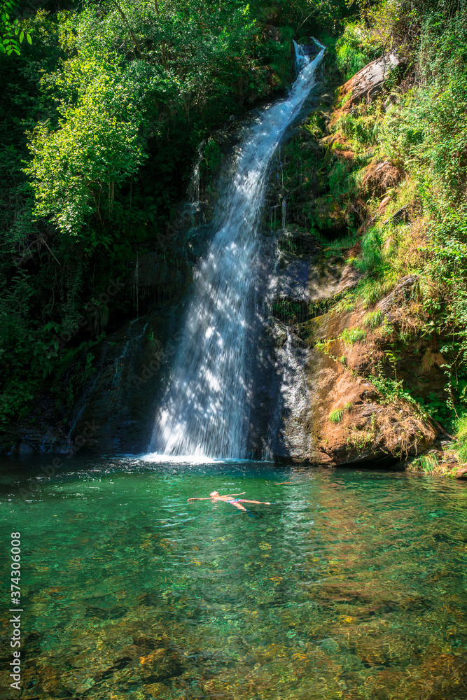A Seara, Galicia / Spain - August 11, 2020: Fervenza de Vieiros in River Selmo / Man bathing in the river A Seara, Galicia / Spain - August 11, 2020: Fervenza de Vieiros in River Selmo / Man bathing in the river