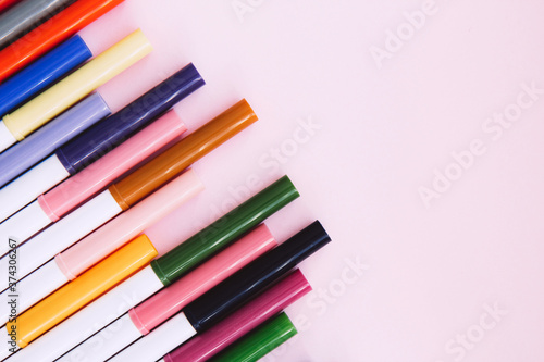 Many colorful marker pen set on pink background. Vivid highlighters and blank space for your design or montage. Background with clipping path. Flat lay