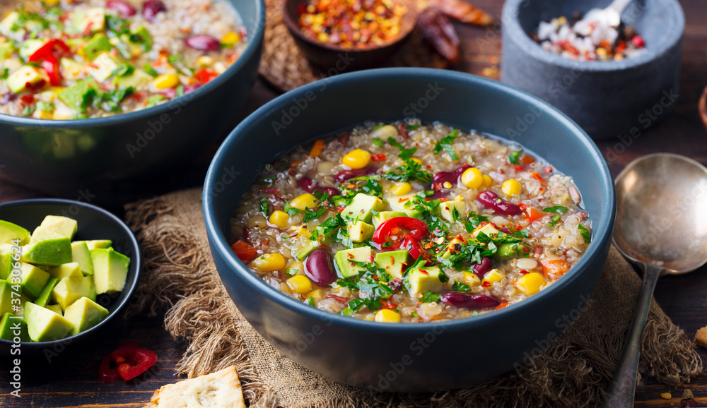 Vegetable quinoa soup, stew with avocado, corn, beans. South American traditional dish. Close up. Vegetable quinoa soup, stew with avocado, corn, beans. South American traditional dish. Close up.