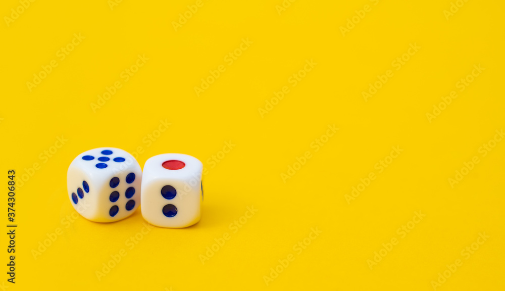 Two game cubes are laid out on a yellow background entertainment