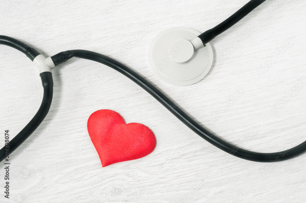 stethoscope and heart on a light background top view. Healthcare concept