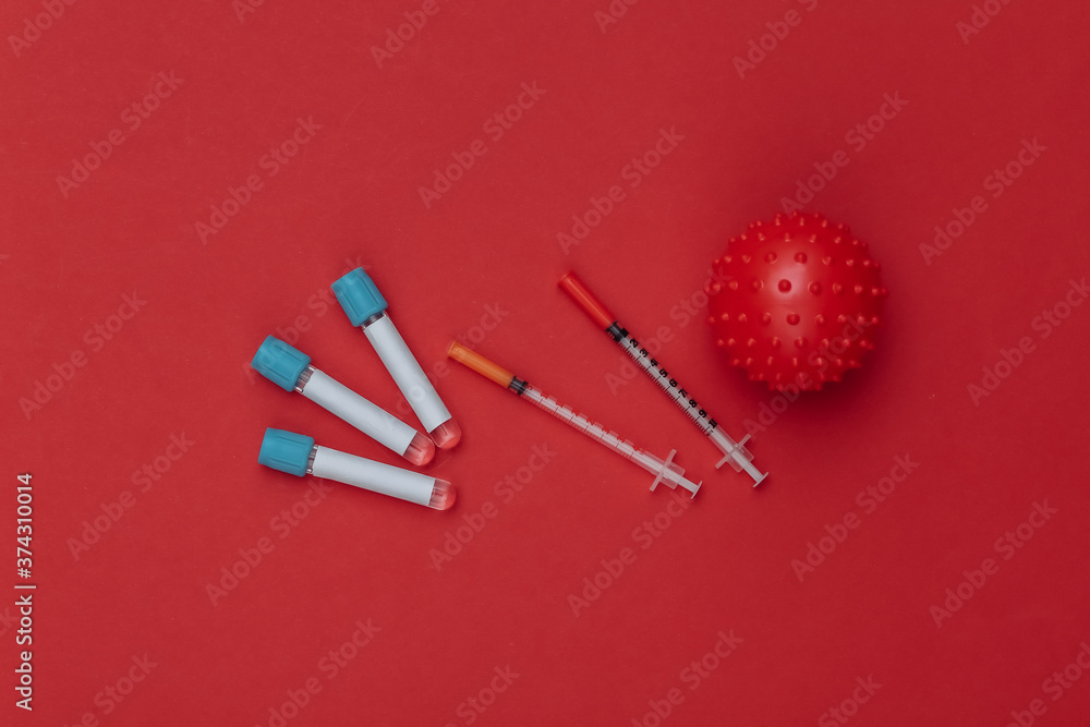 Vaccination. Test tubes with syringes, virus strain model on a red background. Top view Vaccination. Test tubes with syringes, virus strain model on a red background. Top view