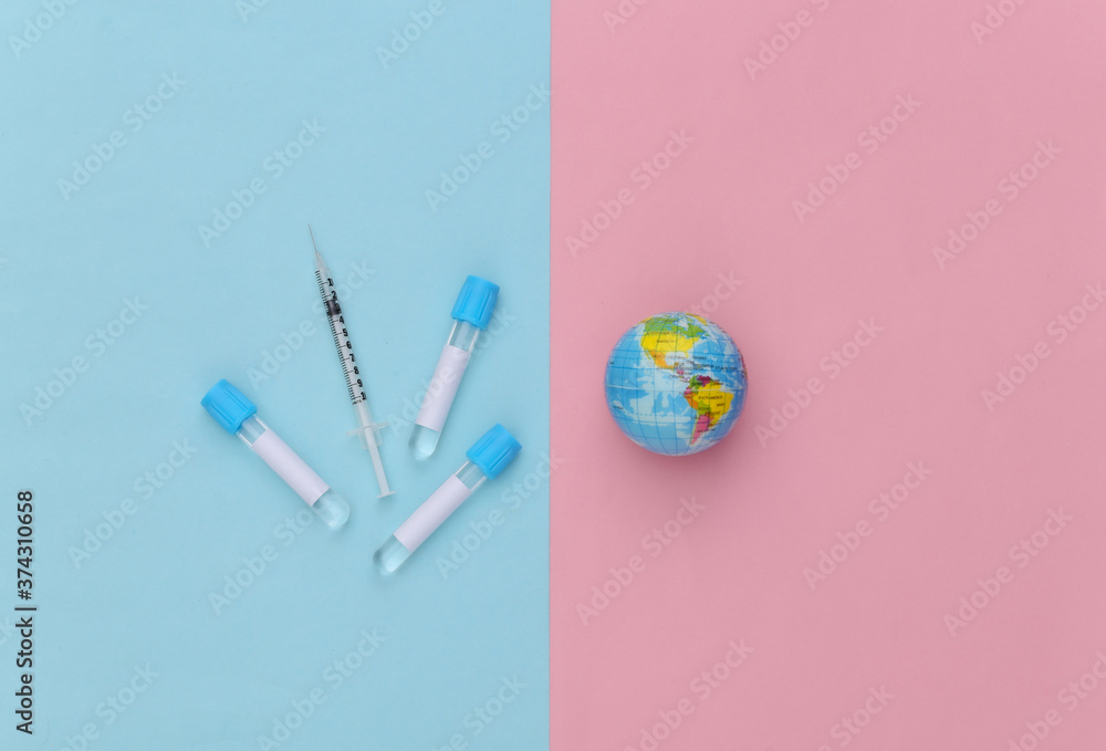 Medical test tubes with syringe, globe on blue pink pastel background. Vaccination. Top view Medical test tubes with syringe, globe on blue pink pastel background. Vaccination. Top view