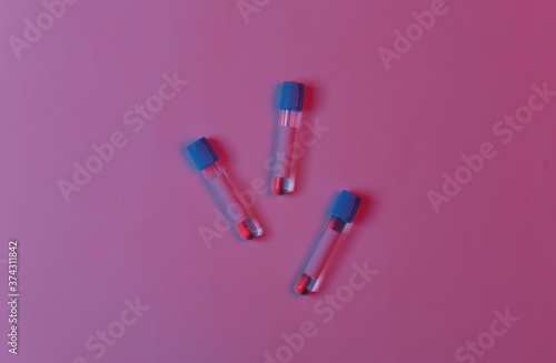 Medical test tubes in red blue gradient neon light. Top view