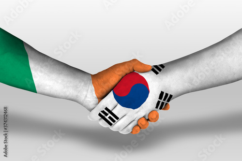 Handshake between south korea and ireland flags painted on hands, illustration with clipping path.
