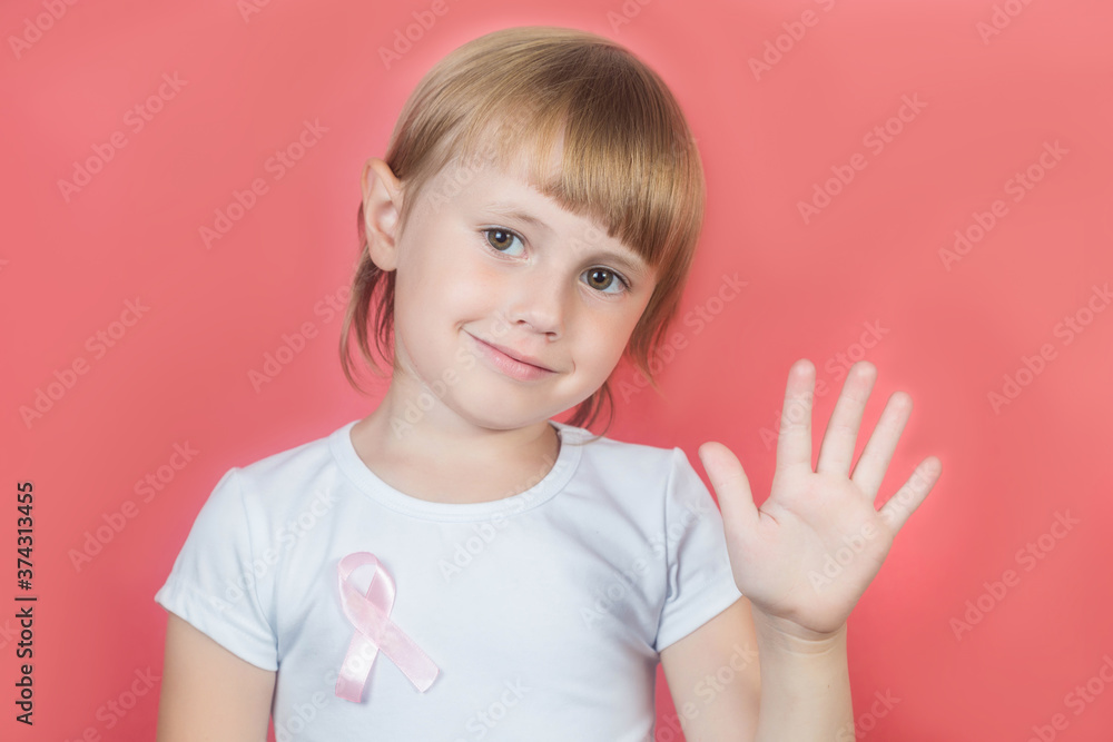 Little girl showing stop sign with hand with pink breast cancer awareness ribbon Little girl showing stop sign with hand with pink breast cancer awareness ribbon