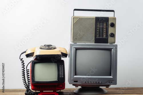 Retro media. Old portable tvs, rotary telephone, radio receiver on a white background