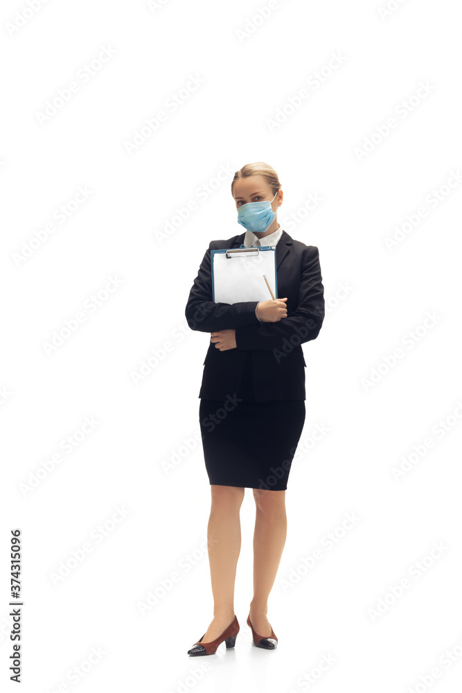 Working in face mask. Young woman, accountant, finance analyst or booker in office suit isolated on white studio background. Caucasian woman, office worker. Finance, economy, professional occupation. Working in face mask. Young woman, accountant, finance analyst or booker in office suit isolated on white studio background. Caucasian woman, office worker. Finance, economy, professional occupation.