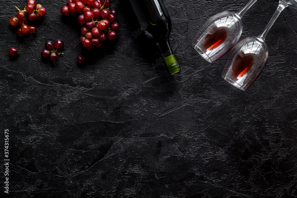 Red wine with grape - in glasses and bottle - on black desk top view copy space Red wine with grape - in glasses and bottle - on black desk top view copy space