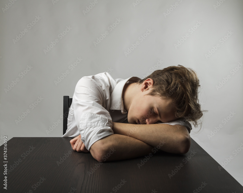 Tired young man. Overtime and fatigue concept. Tired young man. Overtime and fatigue concept.