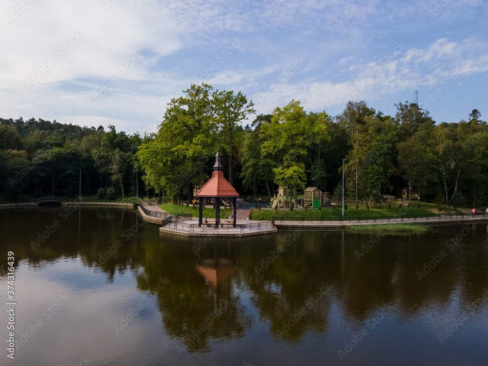 Gazebo on the coast of quiet lake in Svetlogorsk, green trees Gazebo on the coast of quiet lake in Svetlogorsk, green trees