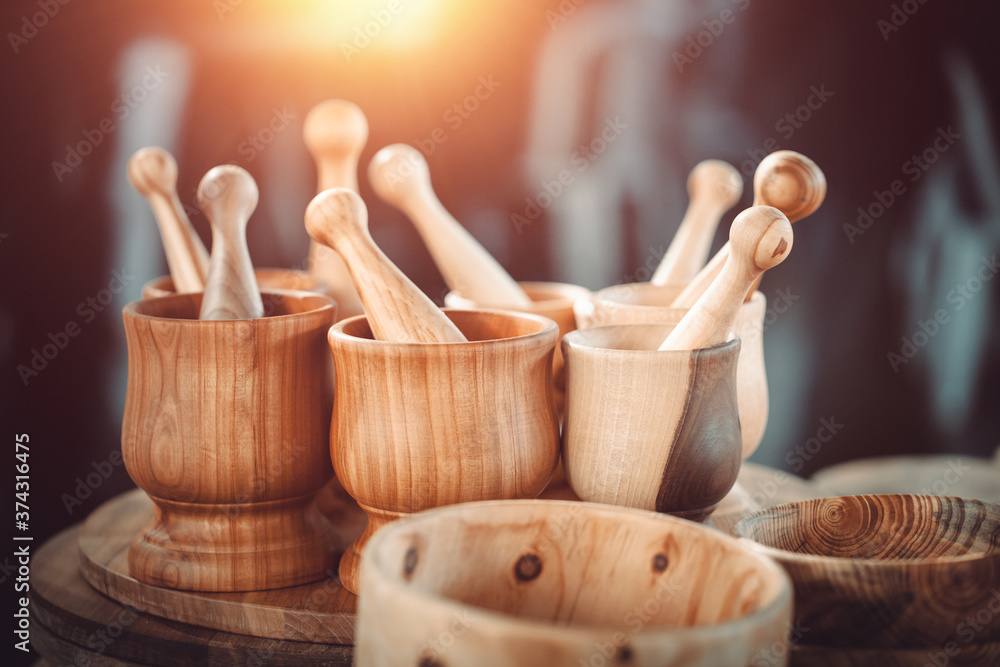 Group of  wooden mortar and pestle with bowls on the countertop at antique bazaar. Shopping at sunday flea market. - obrazy, fototapety, plakaty 