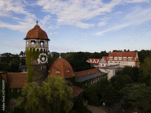 Drone view of water tower in Svetlogorsk in summer, green trees and sea in the background photo