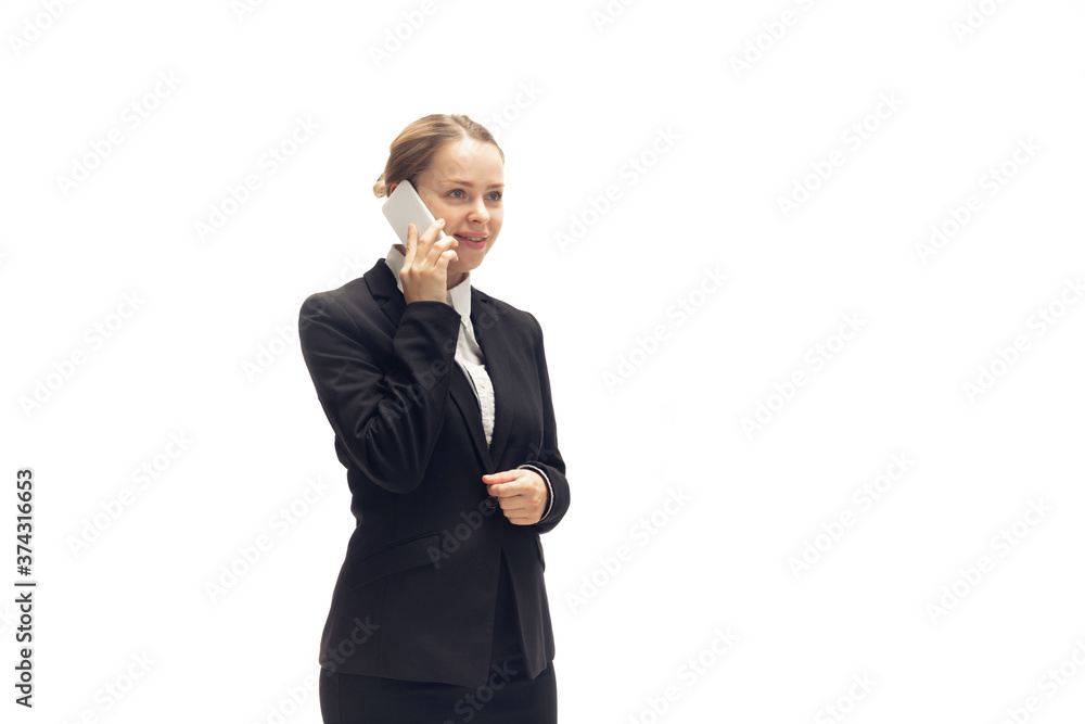 Talking phone. Young woman, accountant, finance analyst or booker in office suit isolated on white studio background. Caucasian woman, office worker. Finance, economy, professional occupation. Talking phone. Young woman, accountant, finance analyst or booker in office suit isolated on white studio background. Caucasian woman, office worker. Finance, economy, professional occupation.