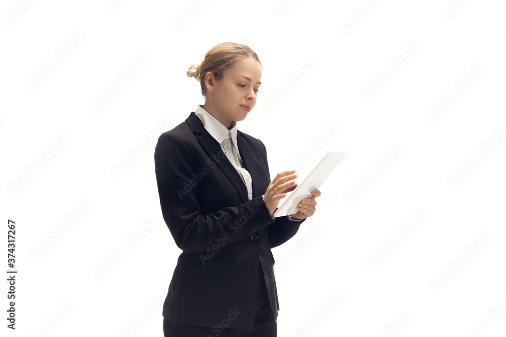Scrolling tablet. Young woman, accountant, finance analyst or booker in office suit isolated on white studio background. Caucasian woman, office worker. Finance, economy, professional occupation. Scrolling tablet. Young woman, accountant, finance analyst or booker in office suit isolated on white studio background. Caucasian woman, office worker. Finance, economy, professional occupation.