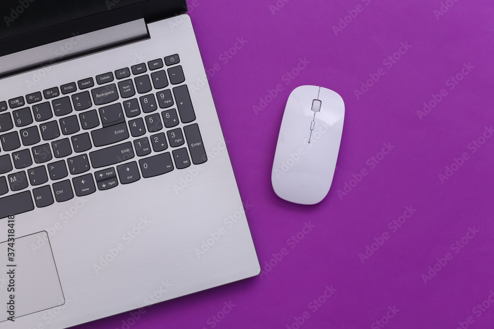 Laptop with pc mouse on purple paper background. Online workspace. Remote work. Studio shot. Top view. Flat lay Laptop with pc mouse on purple paper background. Online workspace. Remote work. Studio shot. Top view. Flat lay