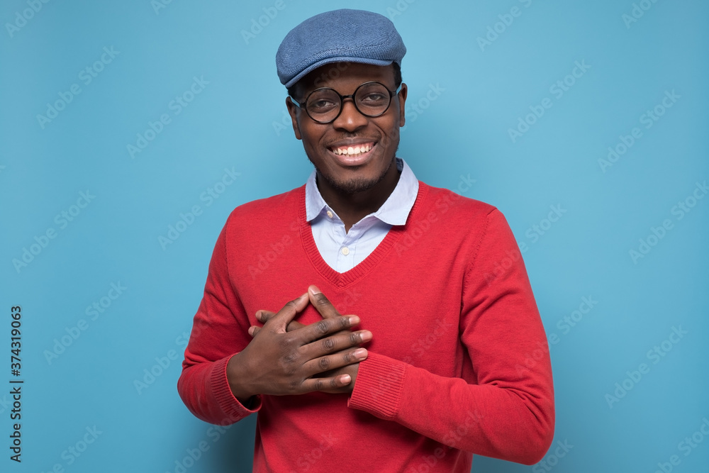 man smiles happily, keeps hands on chest, recieve compliment from woman man smiles happily, keeps hands on chest, recieve compliment from woman