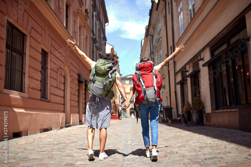 Tourist Man and Woman with a backpack Traveling, Walking On Street.