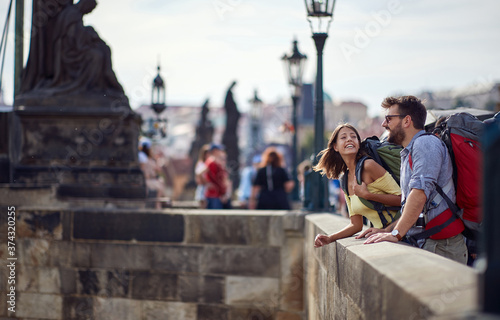 young couple in love walking on a street of Prague city. © luckybusiness