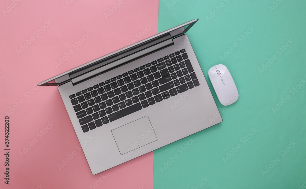 Laptop with pc mouse on pink blue background. Online workspace. Remote work. Studio shot. Top view. Flat lay Laptop with pc mouse on pink blue background. Online workspace. Remote work. Studio shot. Top view. Flat lay