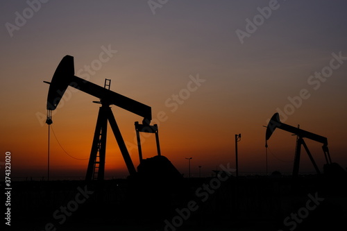silhouette of oil pump with sunset in Bahrain