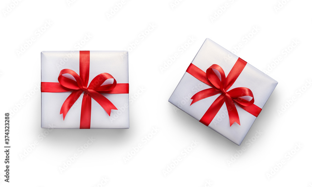 Top view of Christmas, birthday presents wrapped in white paper with red ribbon and bow decoration isolated against a white background. Top view of Christmas, birthday presents wrapped in white paper with red ribbon and bow decoration isolated against a white background.