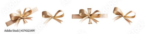 A collection of gold ribbon bows for Christmas, birthday and valantines presents isolated against a white background photo