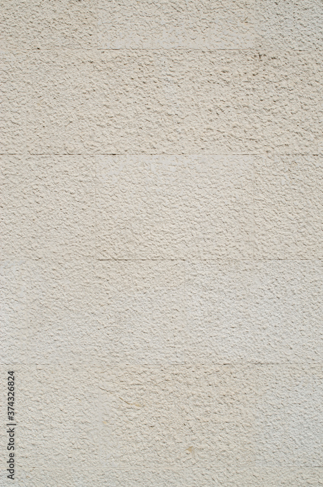 Fototapeta premium New ecru stone slabs on wall closeup