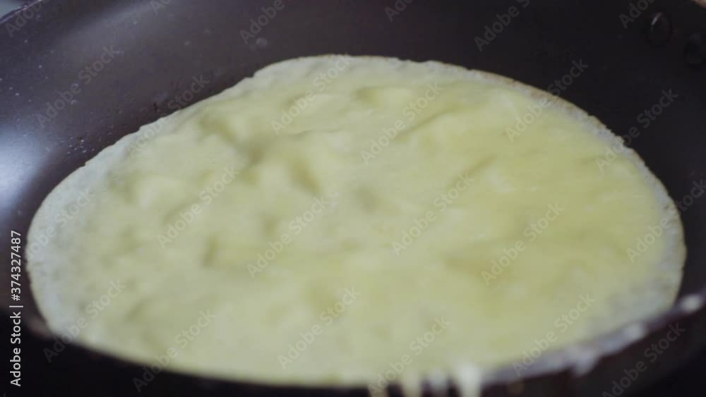 Cooking Russian pancake in old frying pan on top of electric stove. Cooking Russian pancake in old frying pan on top of electric stove.
