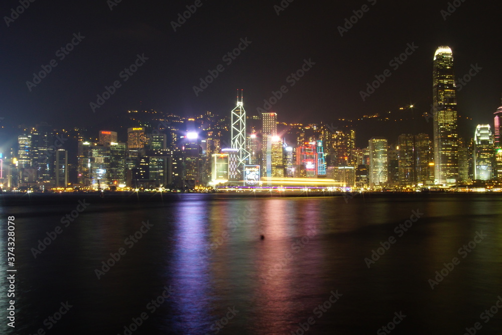 Fototapeta premium City landscape. Victoria Harbor and Hong Kong skyscrapers at night.