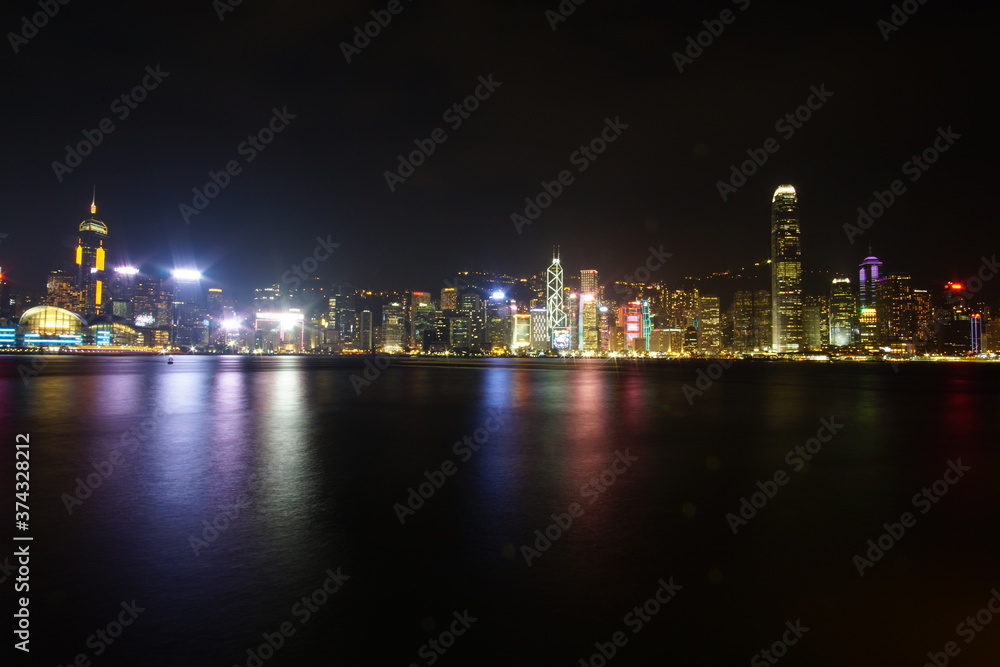 City landscape. Victoria Harbor and Hong Kong skyscrapers at night.