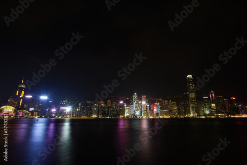 City landscape. Victoria Harbor and Hong Kong skyscrapers at night.