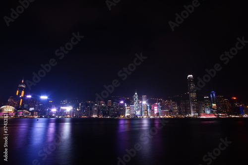 City landscape. Victoria Harbor and Hong Kong skyscrapers at night